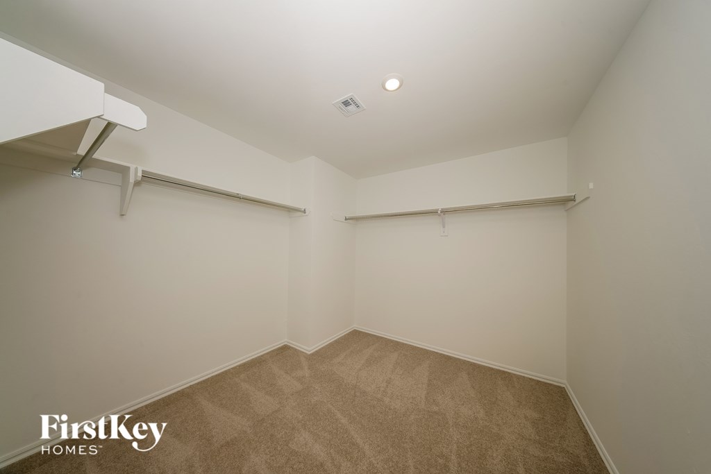 A room with a carpeted floor and white walls.