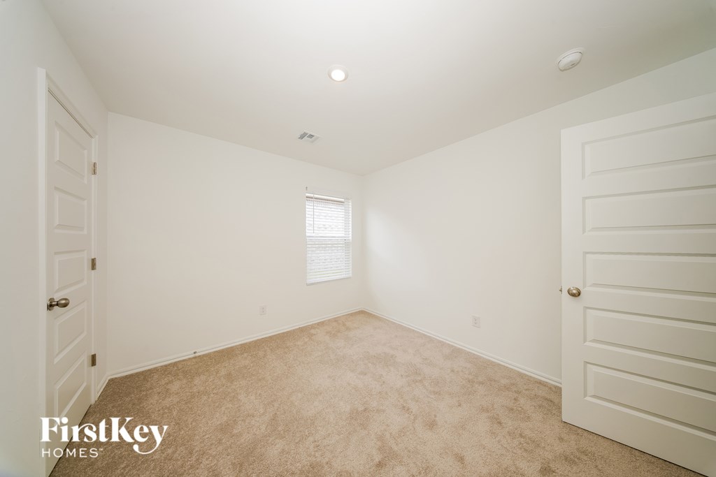 A room with a carpeted floor and white walls.