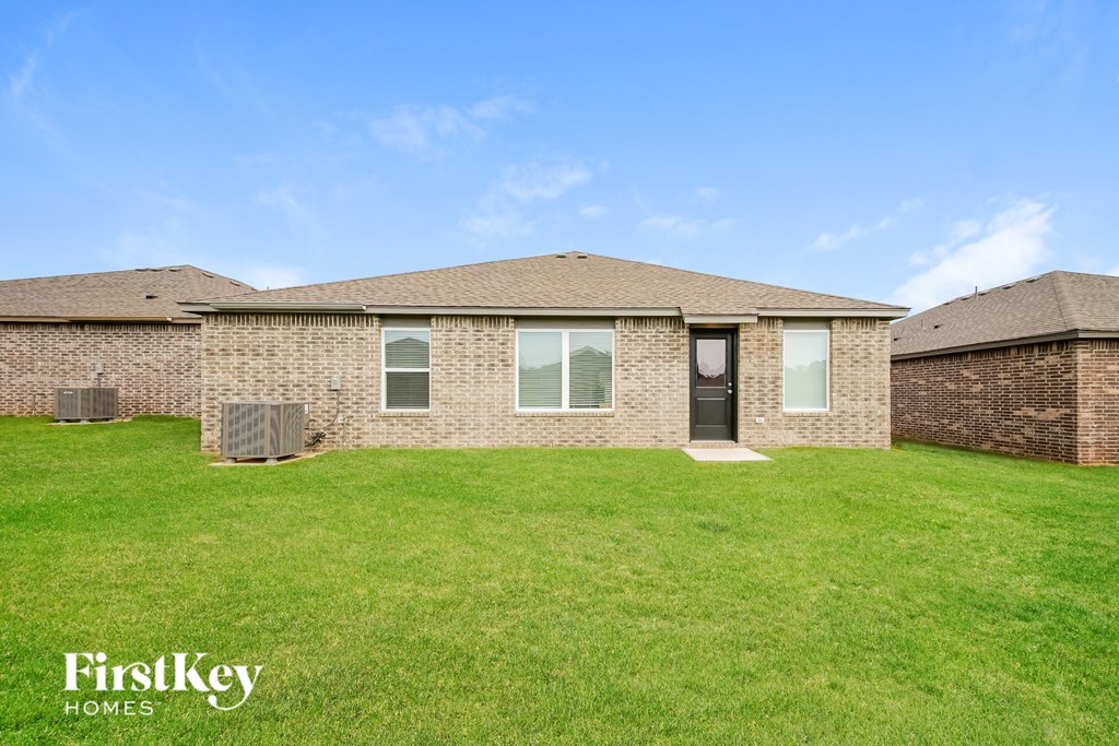 A brick house with a black door and windows.