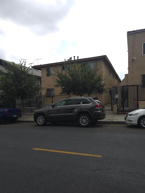 A black SUV is parked in a parking space on a cloudy day.