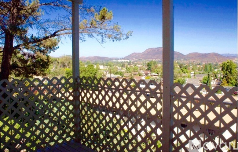 A view from a porch with a lattice fence.