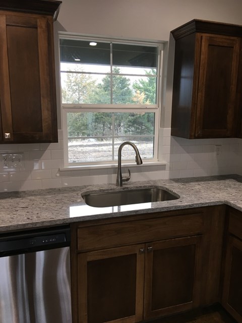 A kitchen with a sink and a window.