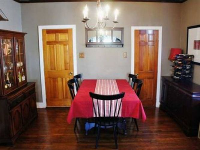 A dining room with a table set for four.