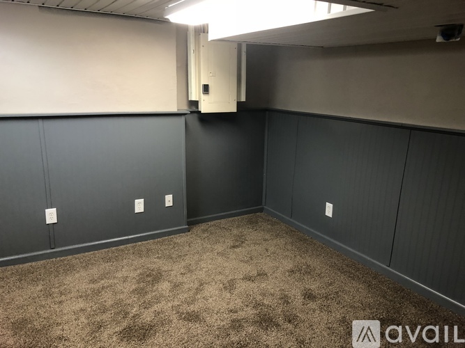 A room with grey walls and carpeted floor.