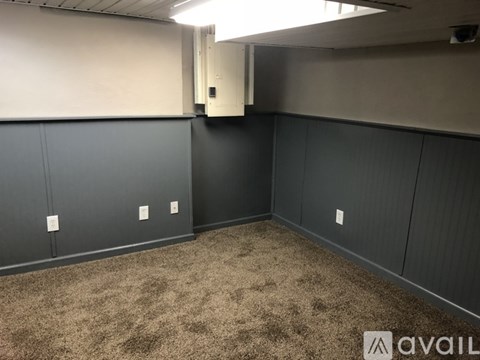A room with grey walls and carpeted floor.