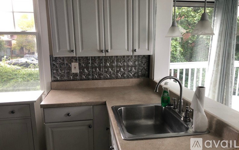 A kitchen with a sink and a window.