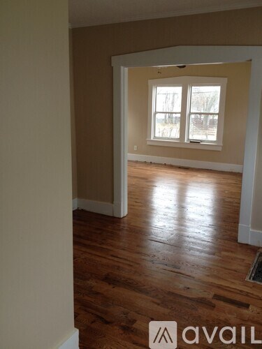 A room with wooden floors and a window.