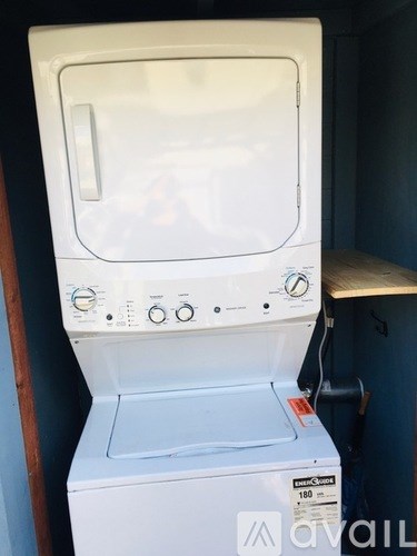 A white front loading washing machine with the door open.