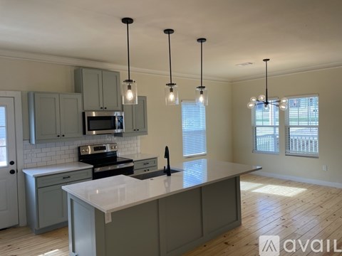 A kitchen with a large island in the middle.