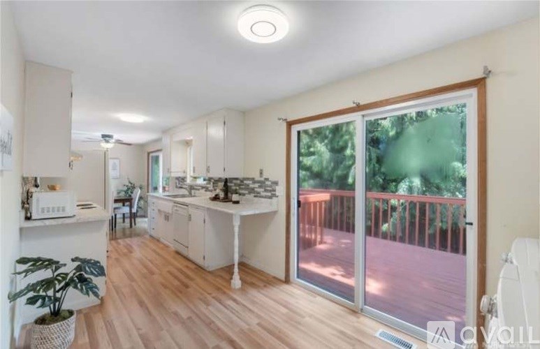 A kitchen with a balcony and sliding glass doors.