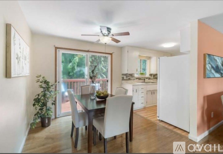 A dining room with a table and chairs is shown.