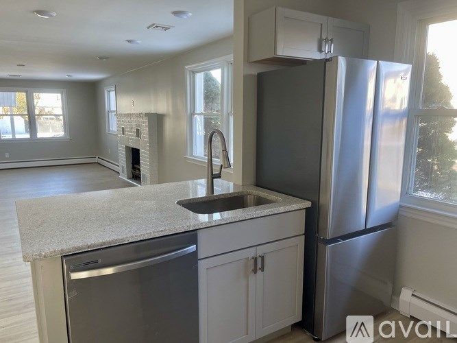 A kitchen with a granite countertop and stainless steel appliances.