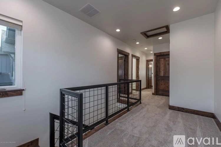 A spacious room with a balcony and a window.