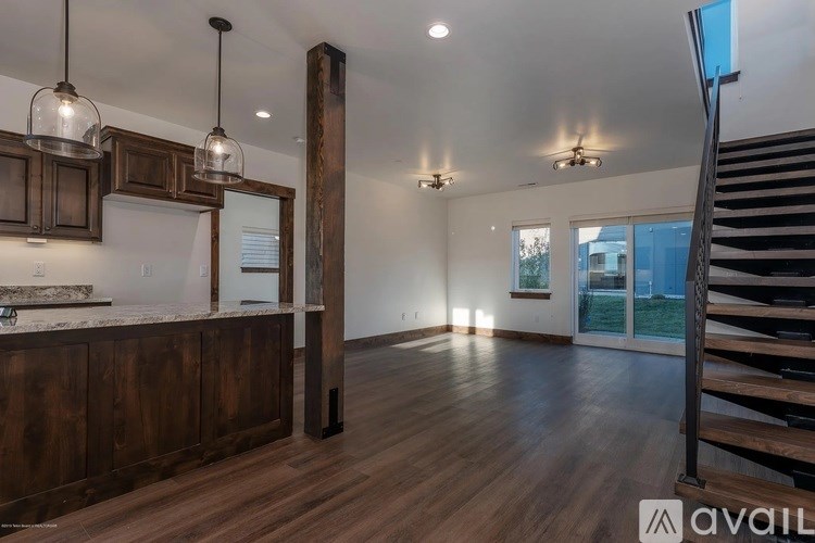 A modern kitchen with dark wood cabinets and a central island.