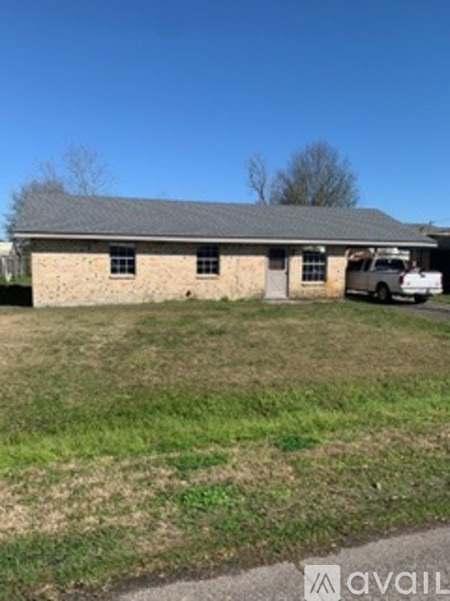 A house with a car parked in front.