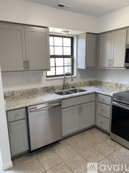 A kitchen with granite countertops and stainless steel appliances.