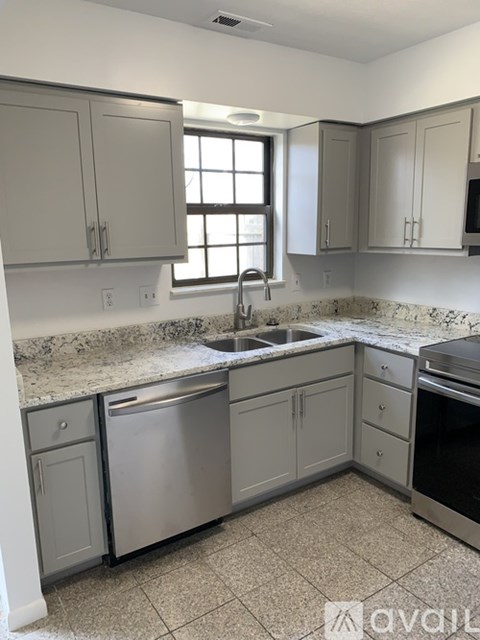 A kitchen with granite countertops and stainless steel appliances.