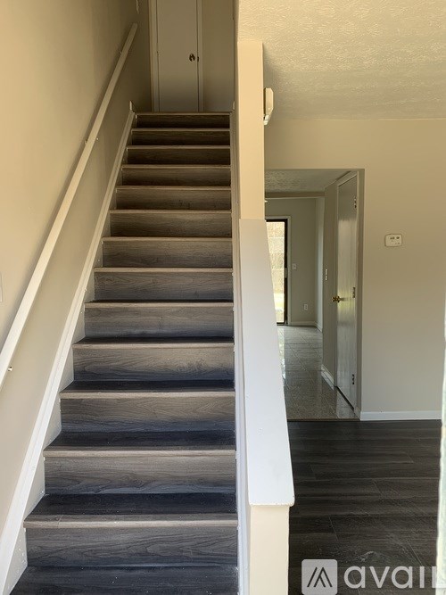 A staircase with wooden steps and white railings.