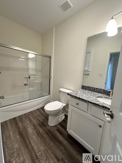 A bathroom with a toilet, sink, and bathtub.