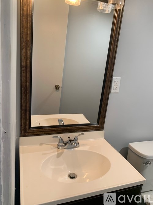 A bathroom sink with a mirror above it.