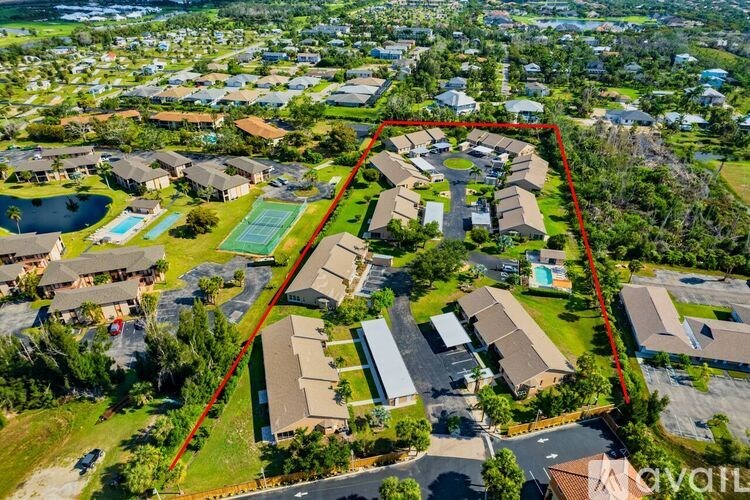 A bird's eye view of a residential area with a red line demarcating a boundary.