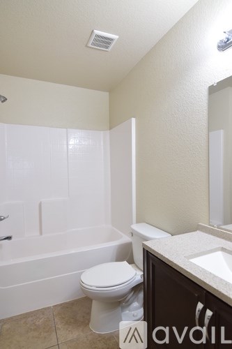 A bathroom with a toilet, sink, and bathtub.