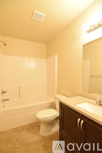 A bathroom with a toilet, sink, and bathtub.