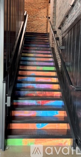 A set of stairs with a rainbow pattern on the treads.