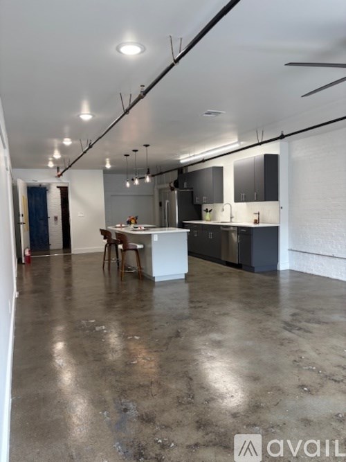 A kitchen area with a table and chairs in the middle of the room.