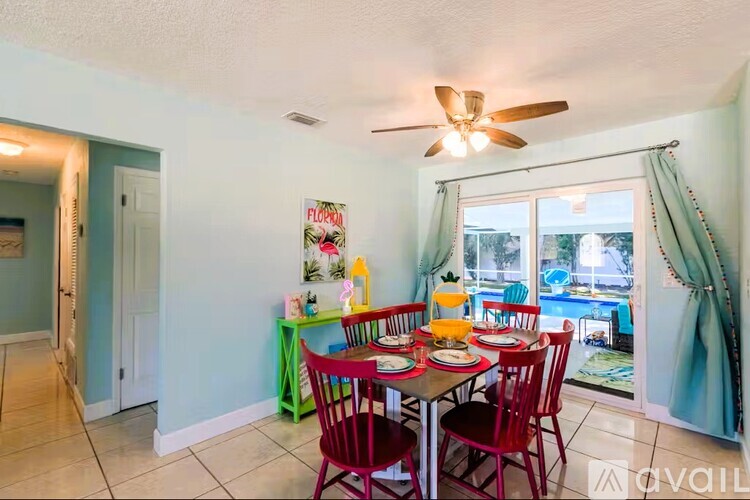 A kitchen with a white counter and blue stools.
