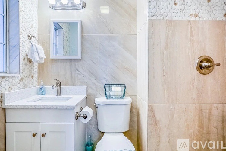 A bathroom with a white toilet and a sink with a mirror above it.