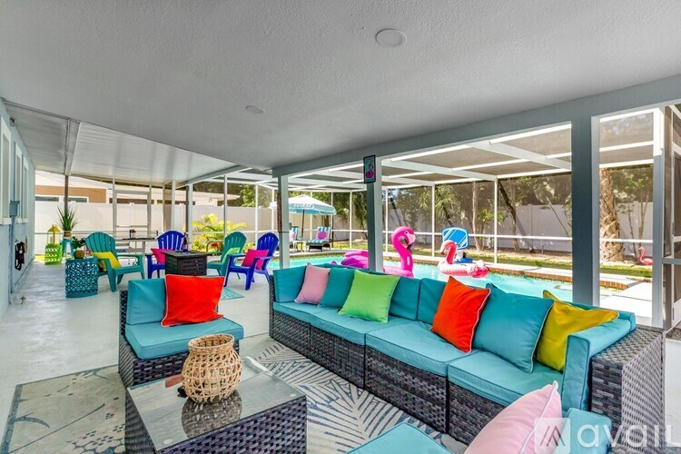 A brightly colored outdoor seating area with a glass table and chairs.