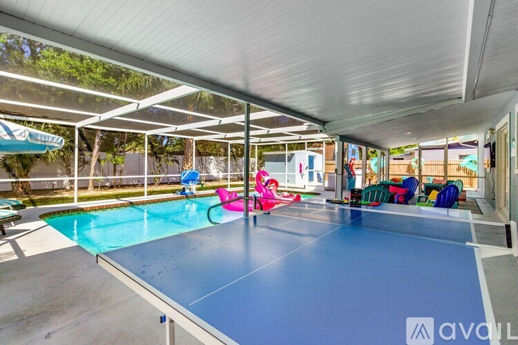 A ping pong table is in the middle of a room with a pool table and a table tennis table.