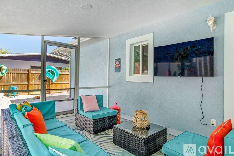 A living room with a sofa and a glass table.