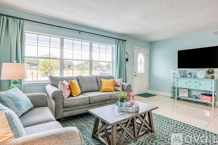 A living room with a grey couch and a coffee table.