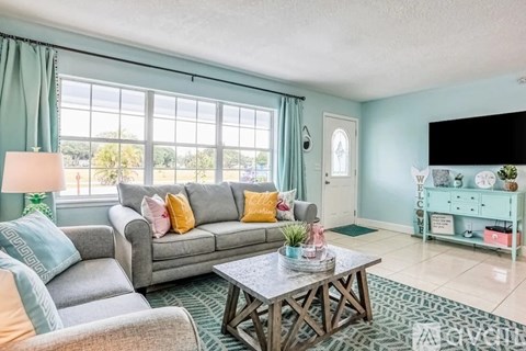 A living room with a grey couch and a coffee table.