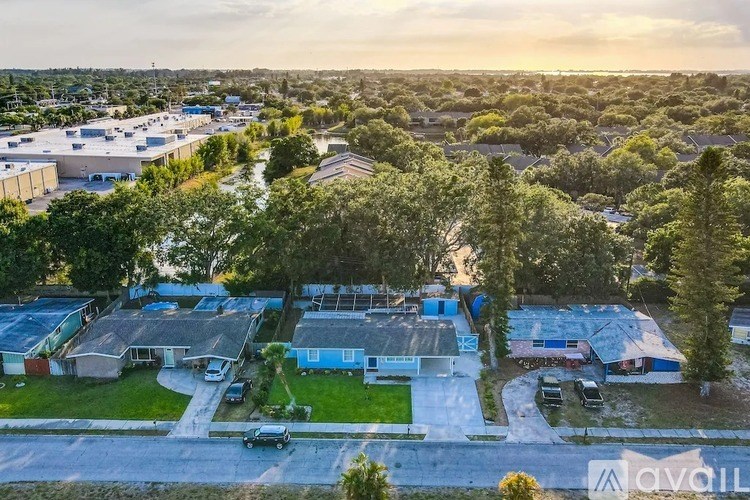 A bird's eye view of a residential area with houses and trees.