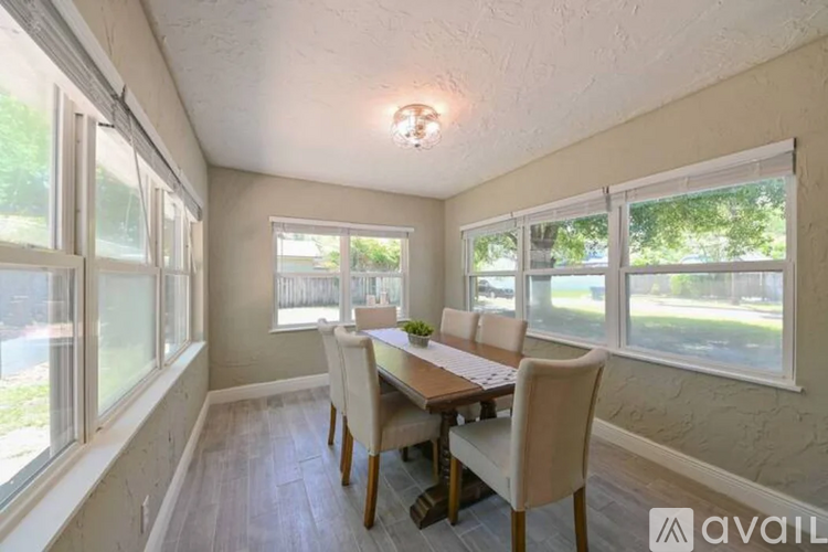 A dining room with a table and chairs.