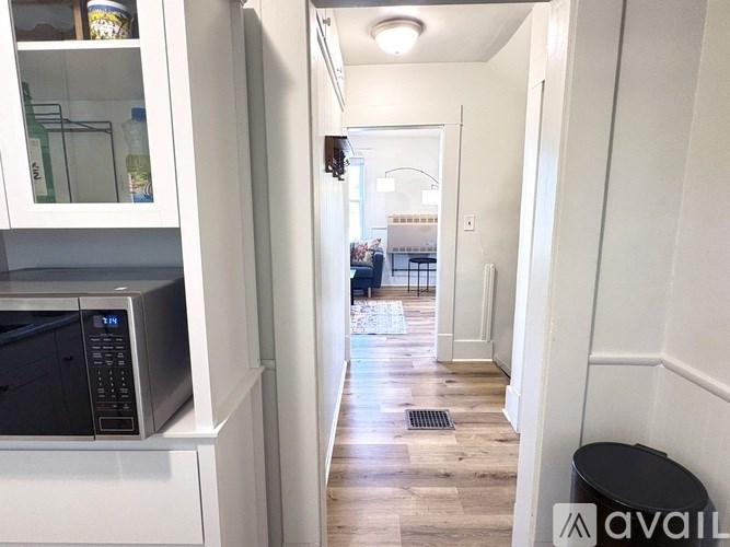 A white bathroom with a toilet, sink, and shower.