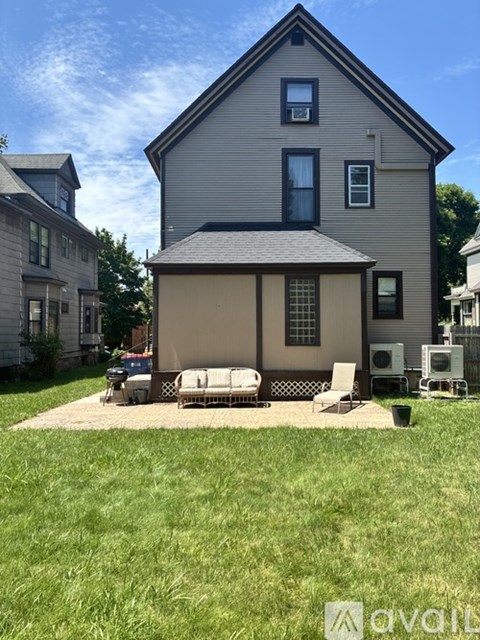 A house with a grey exterior and a covered patio area.