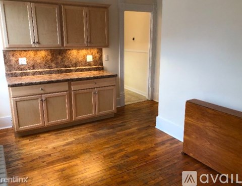 A kitchen with wooden cabinets and a countertop.