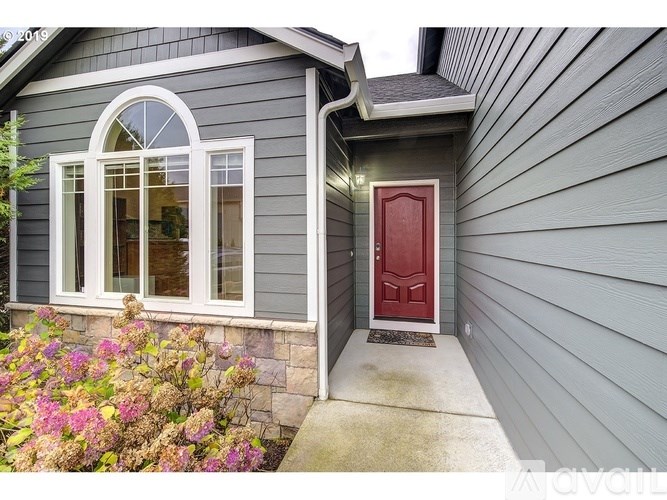A house with a red door and a window with white trim.