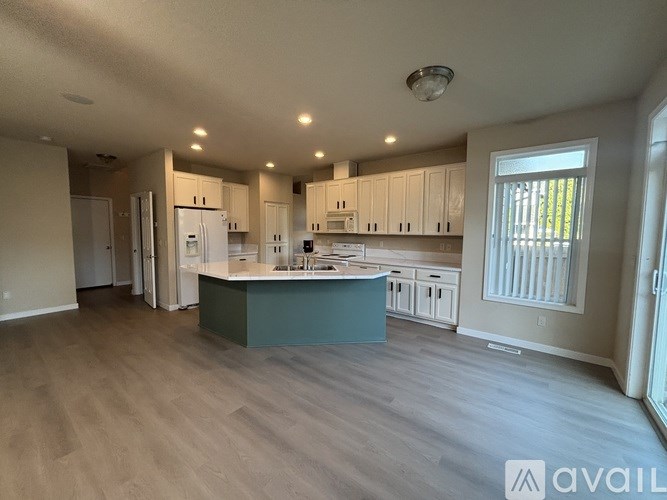 A spacious kitchen with a large island in the middle.