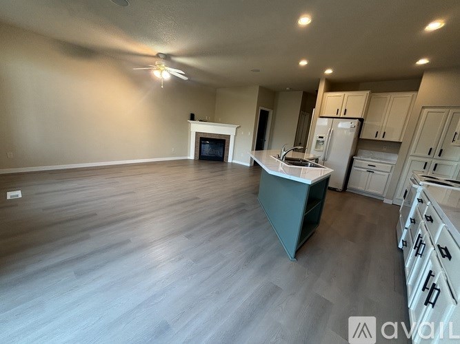 A spacious kitchen with a refrigerator, stove, and oven.