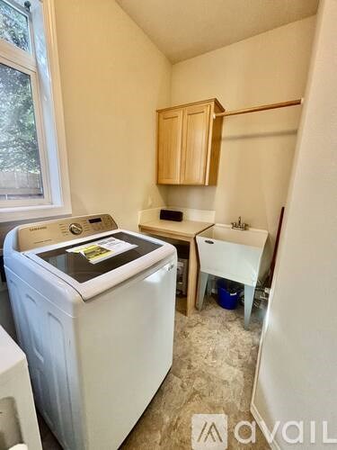 A small laundry room with a washer and dryer.