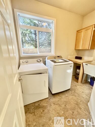 A small laundry room with a washer and dryer.