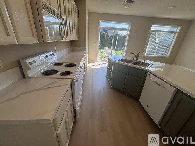 A kitchen with a stove top oven and a dishwasher.