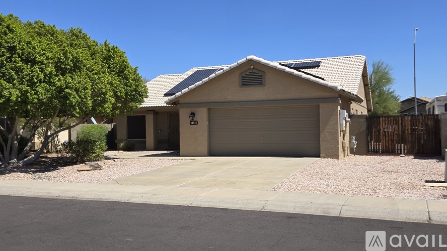 A house with a garage and a driveway in front of it.