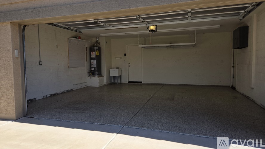 A garage with a concrete floor and a white wall.