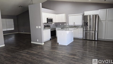 A kitchen with a white island in the middle of the room.